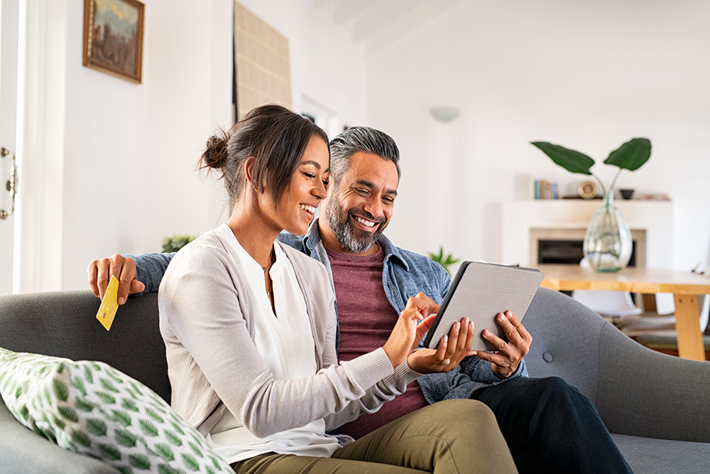 A couple looking at a tablet at home