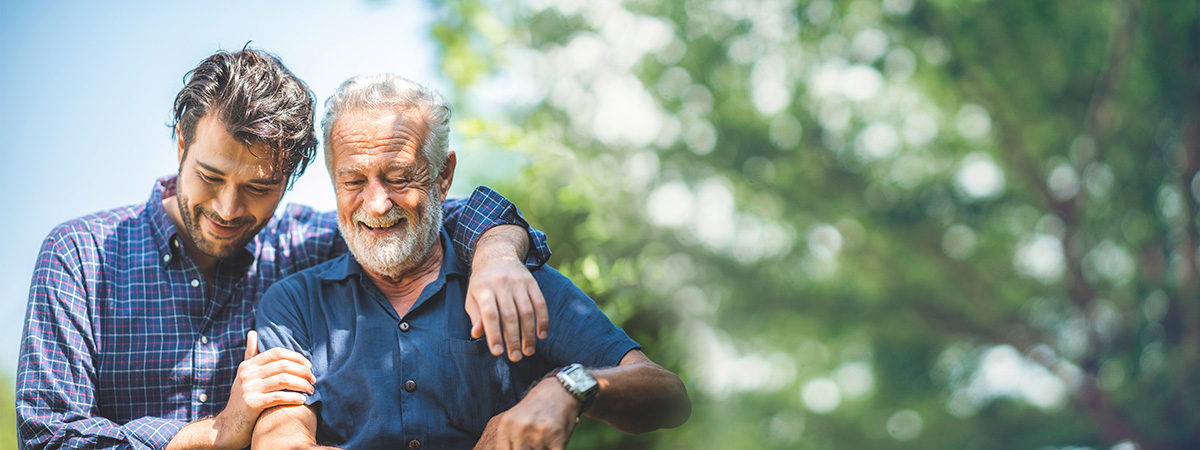 An older man with a loved one outdoors